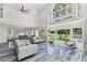Airy living area with high ceilings, stylish furnishings, and pool table at 3663 Berger Rd, Lutz, FL 33548