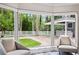 Inviting living area with serene backyard views, elegant furniture, and brick patio access at 3663 Berger Rd, Lutz, FL 33548
