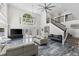 Stunning living room with soaring ceilings and elegant staircase at 3663 Berger Rd, Lutz, FL 33548