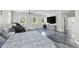Spacious main bedroom with modern floors, large windows, ceiling fan, and sitting area with massage chair at 3663 Berger Rd, Lutz, FL 33548