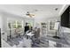 Modern office with many windows and a ceiling fan at 3663 Berger Rd, Lutz, FL 33548