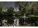 Serene pond with a fountain, surrounded by lush greenery creating a peaceful and picturesque setting at 3663 Berger Rd, Lutz, FL 33548