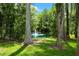 Picturesque pond with a fountain, surrounded by lush greenery and mature trees at 3663 Berger Rd, Lutz, FL 33548