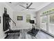 Workout room features modern exercise equipment and French doors to the outside at 3663 Berger Rd, Lutz, FL 33548