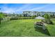 Expansive backyard featuring lush lawn, black metal fence, and outdoor play area at 4608 Emprise Way, Land O Lakes, FL 34638