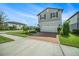 Two-story home with a two-car garage, red brick driveway and a beautifully landscaped front yard at 4608 Emprise Way, Land O Lakes, FL 34638