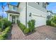 Charming front exterior featuring an attached garage, neatly manicured bushes, and a brick walkway at 4608 Emprise Way, Land O Lakes, FL 34638