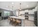Bright kitchen features a spacious island, stainless appliances, and opens to the dining area at 4608 Emprise Way, Land O Lakes, FL 34638