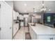 Well-equipped kitchen with stainless steel appliances, white cabinetry, and a tile backsplash at 4608 Emprise Way, Land O Lakes, FL 34638