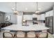 Well-designed kitchen with stainless steel appliances, white cabinets, and a large center island at 4608 Emprise Way, Land O Lakes, FL 34638