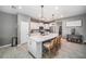 Bright kitchen features a center island with barstool seating and modern pendant lights at 4608 Emprise Way, Land O Lakes, FL 34638