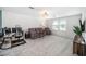 Bright living room features plush carpeting, comfortable seating, and a well-lit desk area at 4608 Emprise Way, Land O Lakes, FL 34638