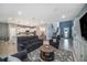 Open-concept living room with cozy seating, a stylish rug, and access to the kitchen at 4608 Emprise Way, Land O Lakes, FL 34638