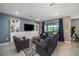 Comfortable living room featuring a built-in bookshelf and tile floors at 4608 Emprise Way, Land O Lakes, FL 34638