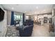 Spacious living room featuring tile flooring, neutral walls, and a view of the open kitchen at 4608 Emprise Way, Land O Lakes, FL 34638