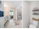 Bright and airy main bathroom featuring double sinks, modern fixtures, and a glass-enclosed shower at 4608 Emprise Way, Land O Lakes, FL 34638
