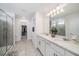Bright and airy main bathroom featuring double sinks, modern fixtures, and a glass-enclosed shower at 4608 Emprise Way, Land O Lakes, FL 34638