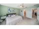 Serene main bedroom with a ceiling fan, neutral walls, and a comfortable bed, with ensuite bathroom at 4608 Emprise Way, Land O Lakes, FL 34638