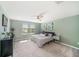 Serene main bedroom with a ceiling fan, neutral walls, and a comfortable bed, bathed in natural light at 4608 Emprise Way, Land O Lakes, FL 34638