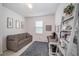 Bright office space with a desk, storage, and a comfortable gray sofa at 4608 Emprise Way, Land O Lakes, FL 34638