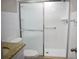 Bathroom with a white tiled shower and glass doors, along with a granite vanity and neutral fixtures at 4702 Michael Ct # 139, Tampa, FL 33614