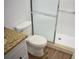 Bathroom featuring granite vanity, toilet, and shower with sliding doors at 4702 Michael Ct # 139, Tampa, FL 33614