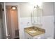 Bathroom vanity with granite counters, stylish mirror, and white tiled walls at 4702 Michael Ct # 139, Tampa, FL 33614