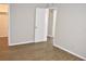 Bedroom with light gray walls, wood laminate flooring, and closet access at 4702 Michael Ct # 139, Tampa, FL 33614
