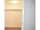 A well-lit closet with white walls, a hanging rod and wooden flooring at 4702 Michael Ct # 139, Tampa, FL 33614