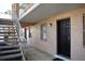 Exterior view of a condo entrance with a black security door, accessible by stairs leading to the second level at 4702 Michael Ct # 139, Tampa, FL 33614