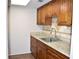 Compact kitchen featuring granite countertops, light-colored backsplash and wood cabinets at 4702 Michael Ct # 139, Tampa, FL 33614