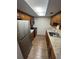 Compact kitchen showcasing a galley layout with stainless steel appliances at 4702 Michael Ct # 139, Tampa, FL 33614