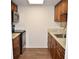 Galley kitchen with stainless steel appliances, light countertops and wood cabinets at 4702 Michael Ct # 139, Tampa, FL 33614