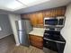 Compact kitchen featuring wood-look floors, stainless steel appliances, and a window at 4702 Michael Ct # 139, Tampa, FL 33614
