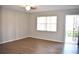Light and airy living room features wood floors, a ceiling fan, and an entrance to an outdoor area at 4702 Michael Ct # 139, Tampa, FL 33614