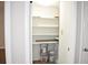 A well-organized pantry with shelves, paint cans, and a broom at 4702 Michael Ct # 139, Tampa, FL 33614
