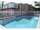 Community pool area, featuring a white fence, ladder entry, and adjacent seating at 4702 Michael Ct # 139, Tampa, FL 33614