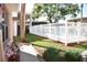 Community pool area with a white fence, landscaping, flowers, and views of the surrounding buildings at 4702 Michael Ct # 139, Tampa, FL 33614