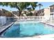 Community swimming pool with multiple entry points, surrounding fence, and adjacent seating at 4702 Michael Ct # 139, Tampa, FL 33614