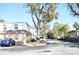 Quiet street view with multi-story condos, mature trees, and parked vehicles at 4702 Michael Ct # 139, Tampa, FL 33614