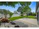 Manicured backyard featuring artificial turf, tropical landscaping, and a concrete patio at 4704 W Fairview Hts, Tampa, FL 33616
