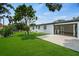 Backyard with artificial turf, patio, and an open door highlighting the indoor-outdoor flow at 4704 W Fairview Hts, Tampa, FL 33616