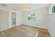 Bedroom with wood floors, updated lighting, and view to the ensuite bath at 4704 W Fairview Hts, Tampa, FL 33616