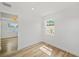Well-lit bedroom featuring wood-look flooring, fresh white paint, and bright windows at 4704 W Fairview Hts, Tampa, FL 33616