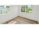 Bright bedroom featuring wood-look flooring and double pane windows offering plenty of natural light at 4704 W Fairview Hts, Tampa, FL 33616