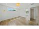 Large bedroom with wood floors, updated lighting and large window at 4704 W Fairview Hts, Tampa, FL 33616