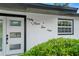 Close-up of home's front entrance with tiled wall featuring address numbers and neatly trimmed landscaping at 4704 W Fairview Hts, Tampa, FL 33616