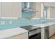 Close-up of updated kitchen with modern appliances, stylish tile backsplash, and plenty of counter space at 4704 W Fairview Hts, Tampa, FL 33616