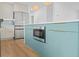 Close up of the kitchen island with seating, a built-in microwave, and modern appliances at 4704 W Fairview Hts, Tampa, FL 33616