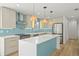 Bright, modern kitchen with stainless steel appliances, a stylish backsplash, and ample counter space at 4704 W Fairview Hts, Tampa, FL 33616